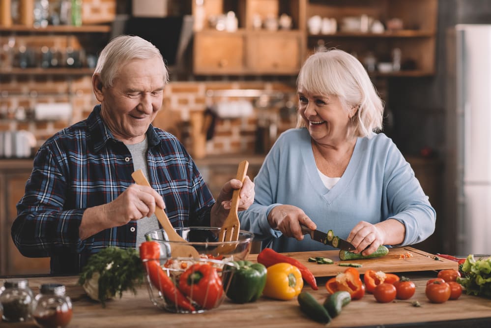 https://www.hearthsideseniorliving.com/wp-content/uploads/2020/10/Smiling-senior-man-and-woman-preparing-vegetables-to-eat.jpg
