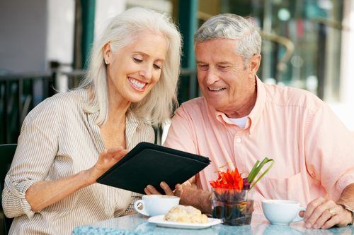 Senior man and woman using tablet