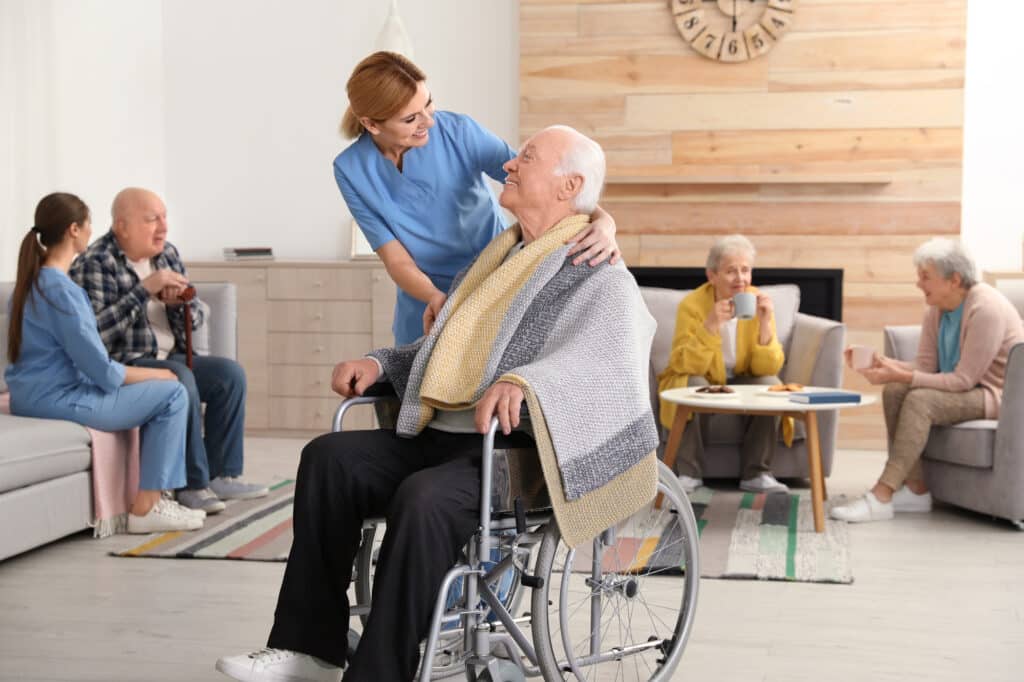 Nurses assisting elderly people at retirement home