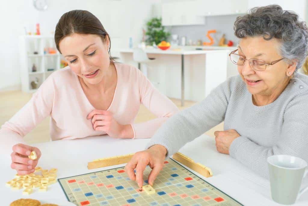 Senior woman playing a board game with middle aged woman