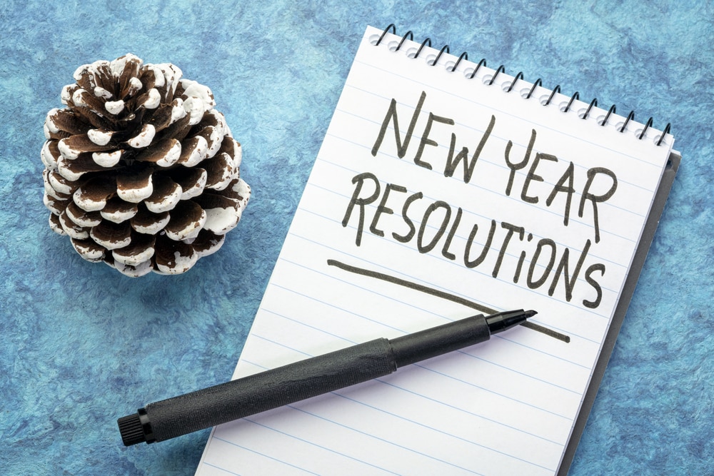 New-Year-Resolutions-written-on-notebook-pen-pinecone