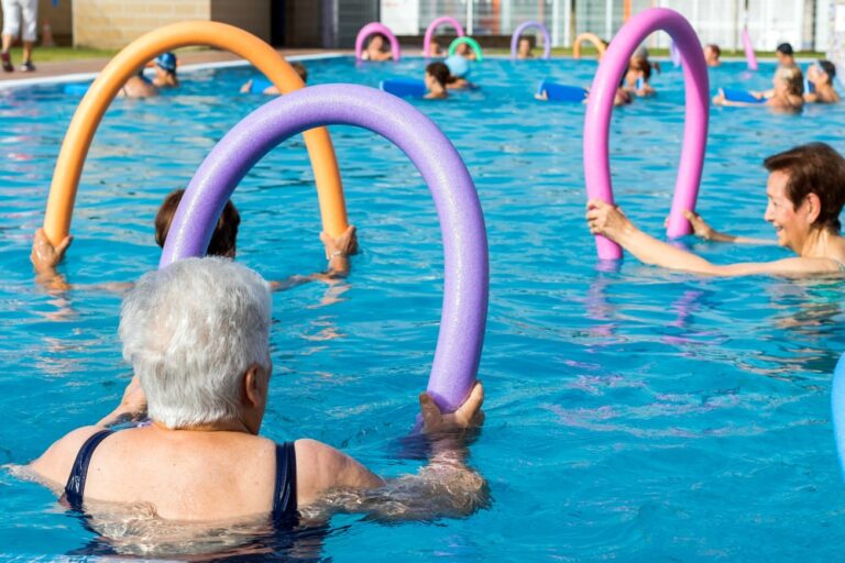Senior-doing-water-aerobics-with-pool-noodles