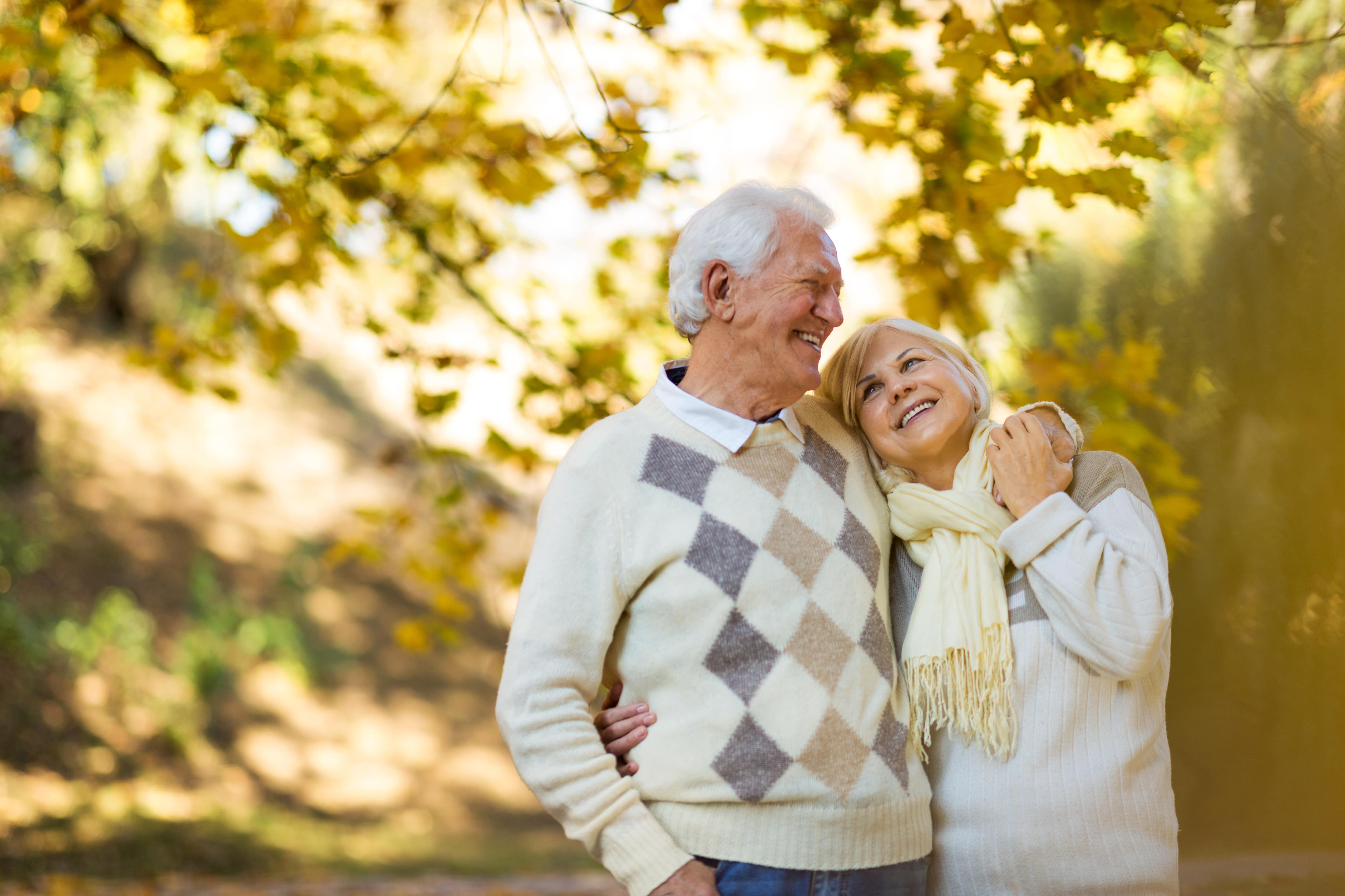 Senior couple in park in fall