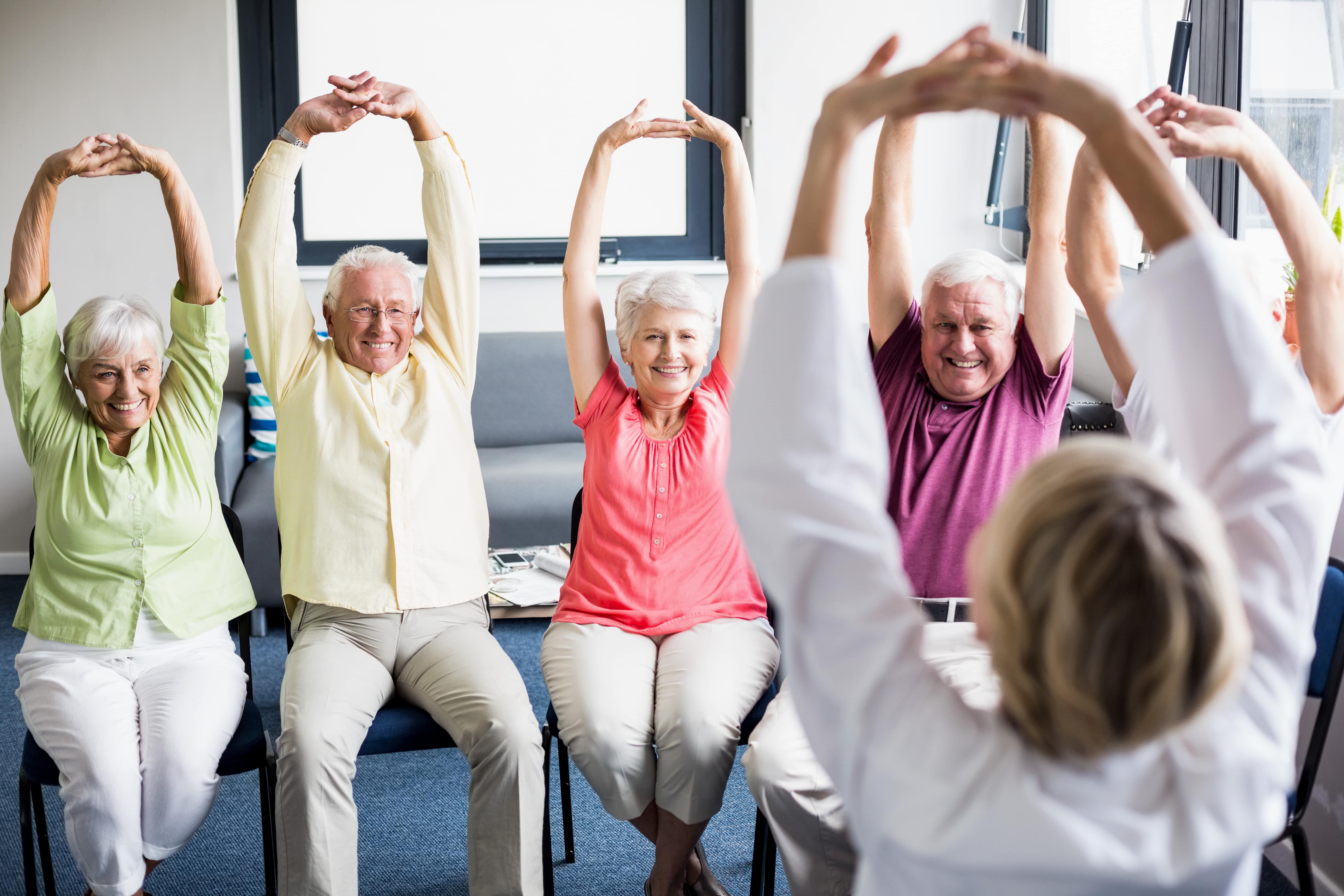 Seniors participating in fitness class at assisted living community